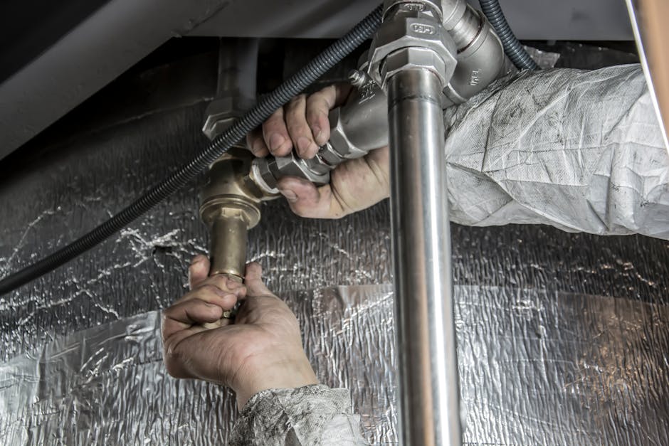 Plumber working on pipes